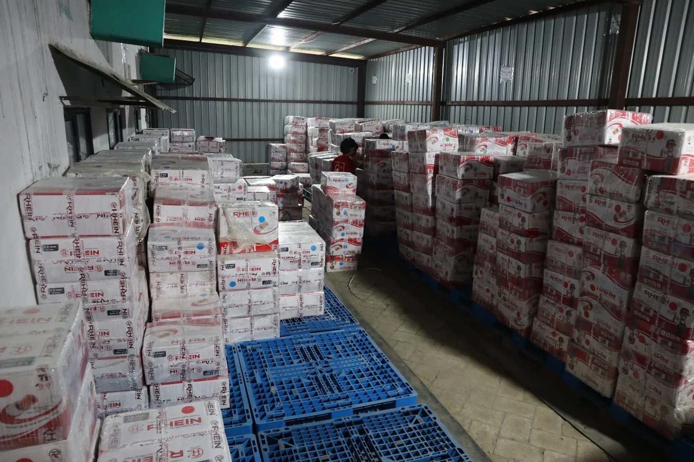 Shrink-wrapped Rhein wire cartons palletised in the finished-goods warehouse