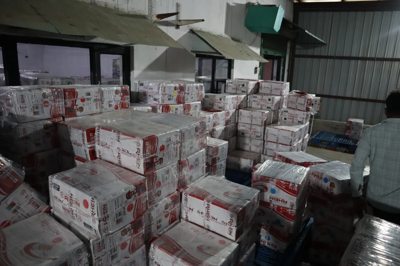 Rhein cartons staged in the dispatch area beside the warehouse office